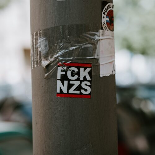 FCK NZS sticker on pole